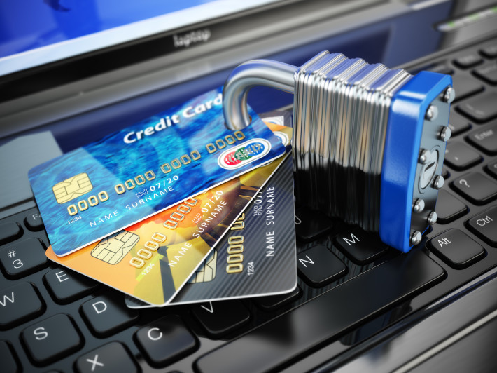 Internet security concept. Credit cards and lock on laptop keyboard. 3d