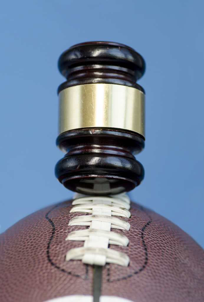 Football with gavel, legal issues connected with the sport concept issue.