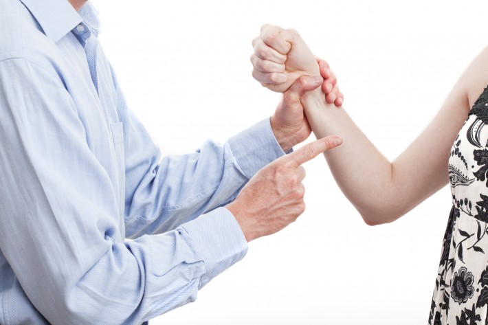Husband-holding-wifes-arm-iStock_27356059-710x473