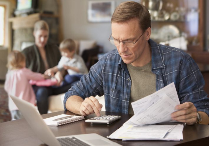 Man-Working-Out-Finances-iStock-137925642-710x496