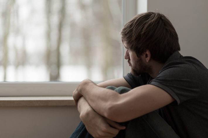 Man-gazing-out-window-iStock-486748776-710x473