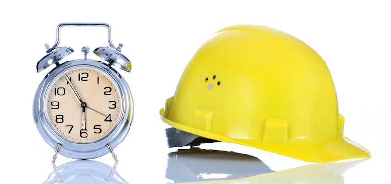 alarm clock and helmet on white background