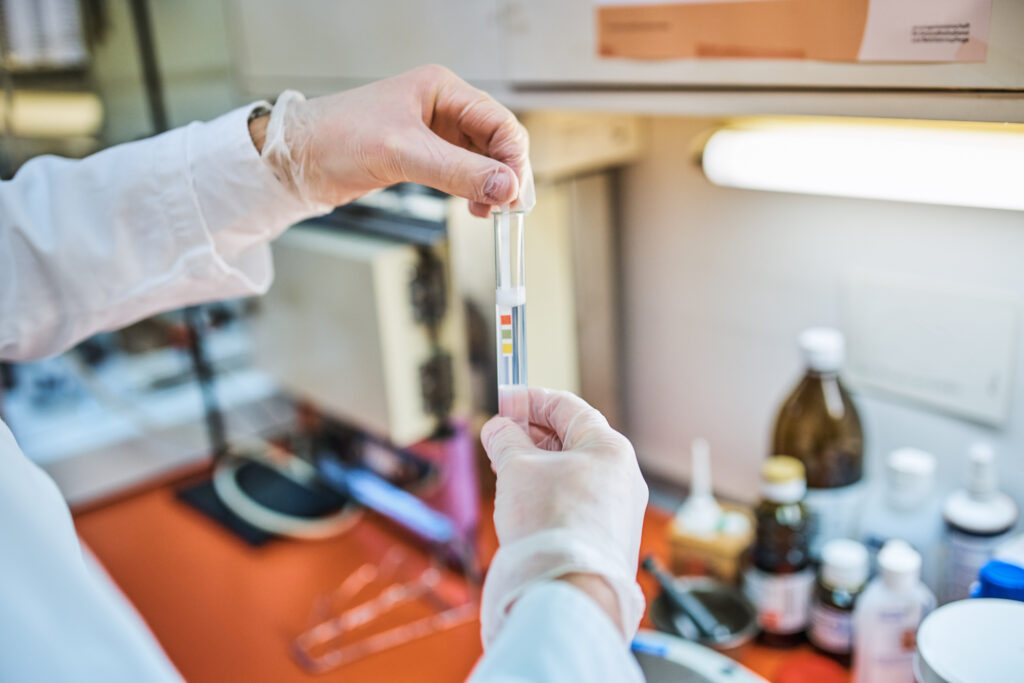 Male scientist doing litmus test in laboratory
