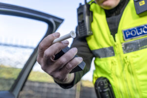 police officer holding a breathalyser